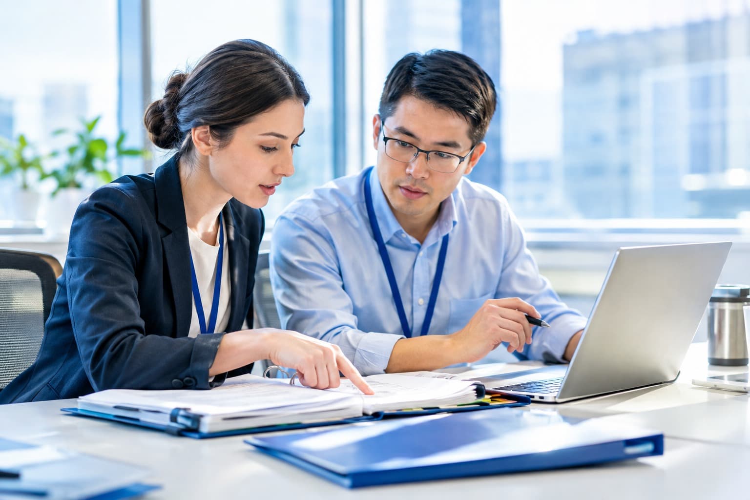 Colleagues reviewing printed documents together